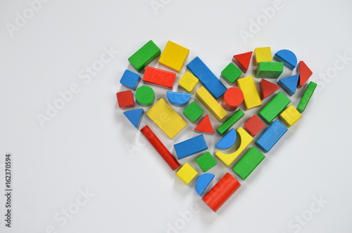 colorful wooden toy blocks shaping the form of a heart