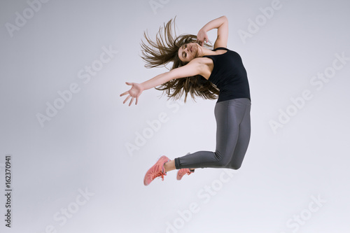 Girl in jump on a gray background
