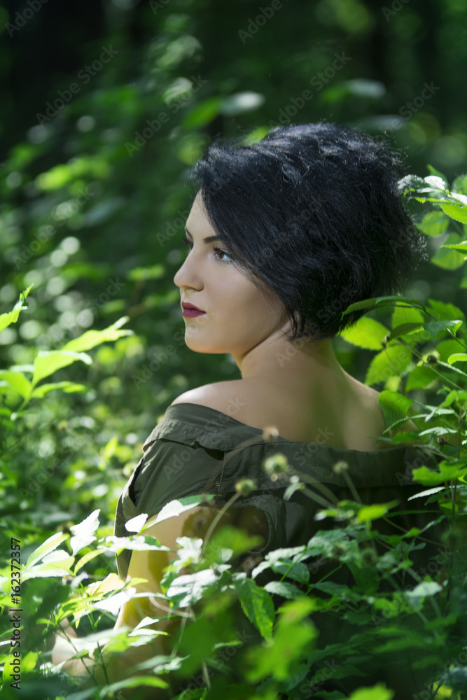 Pretty young girl posing outdoor in a forest Pretty young girl posing outdoor in a forest