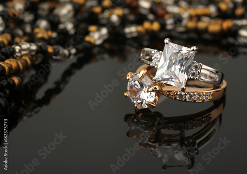 jewelry rings with diamonds on black background, soft focus