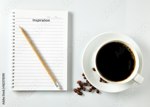White cup of coffee morning on white background with notebook