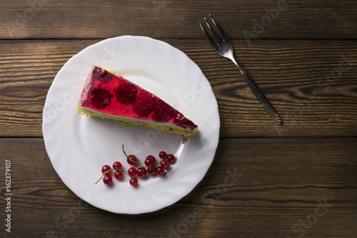 Red currant on brown wooden table