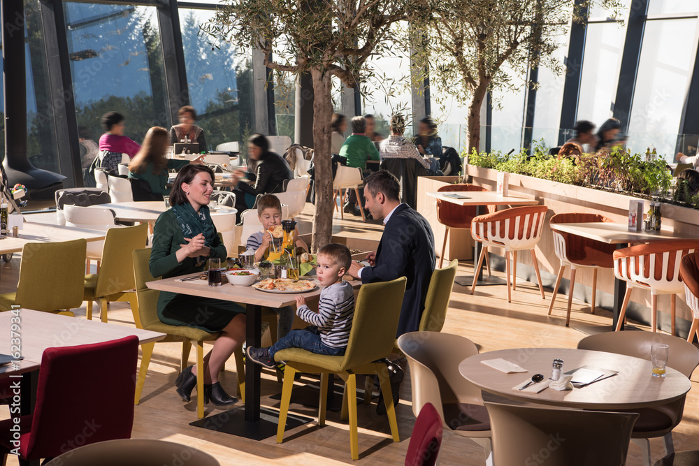 Young parents enjoying lunch time with their children Young parents enjoying lunch time with their children