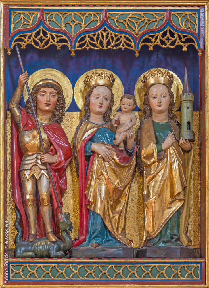 BERLIN, GERMANY, FEBRUARY - 16, 2017: The carved polychrome gothic altar with the Madonna, St. Barbara and St. George in  Dominicans church of St. Pauls by unknown artist of 15. cent.