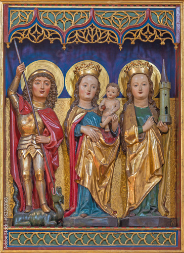BERLIN, GERMANY, FEBRUARY - 16, 2017: The carved polychrome gothic altar with the Madonna, St. Barbara and St. George in Dominicans church of St. Pauls by unknown artist of 15. cent.