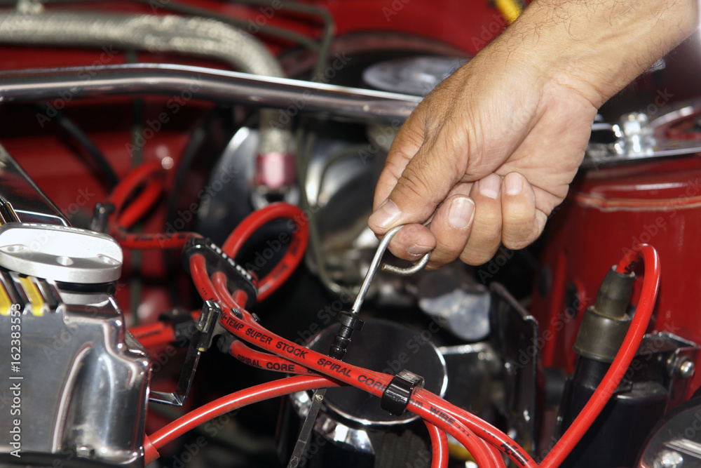 Mechanic checking mototr oil level in a car engine Mechanic checking mototr oil level in a car engine