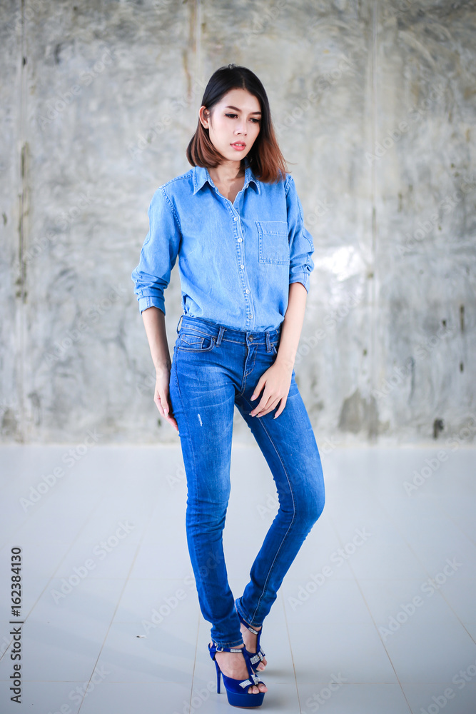 Asian woman casual outfits standing in jeans and blue denim shirt, women brown hair and short hair, beauty and fashion jeans concept Stock Photo | Adobe Stock Asian woman casual outfits standing in jeans and blue denim shirt, women brown hair and short hair, beauty and fashion jeans concept Stock Photo | Adobe Stock