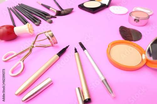 Set of decorative cosmetics on pink color background