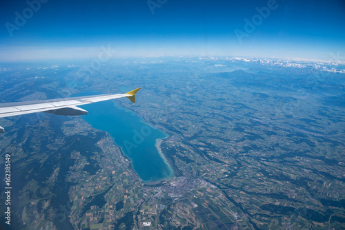 Aerial view of Lac de Neuchâtel or Lake Neuchatel in summer with the alps in the background photo