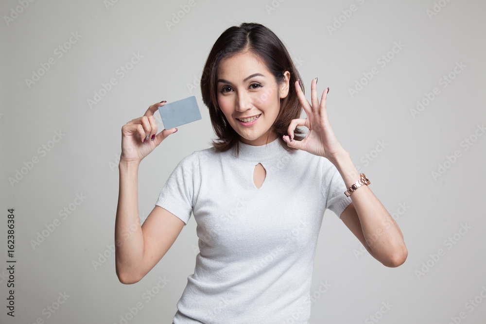 Young Asian woman show OK with a blank card. Young Asian woman show OK with a blank card.