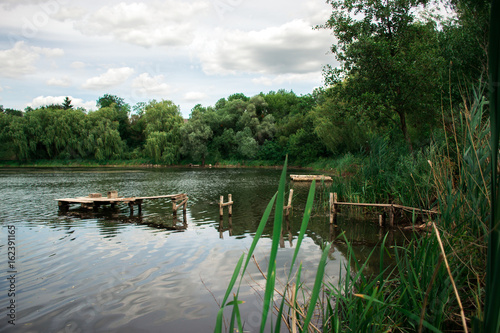 Summer day landscape on a pond in the village.