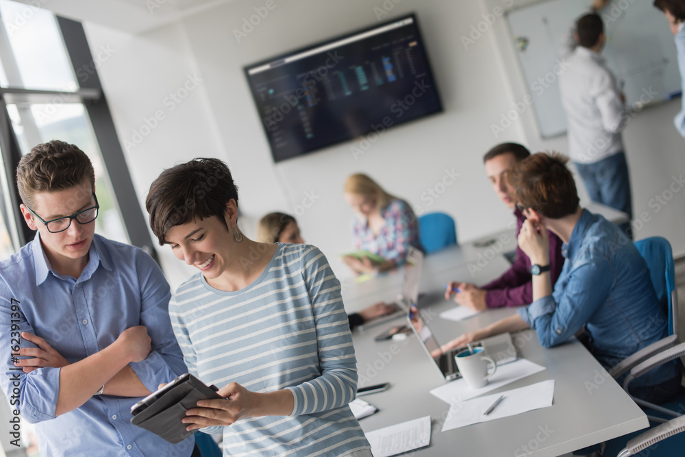 Obraz premium Two Business People Working With Tablet in office