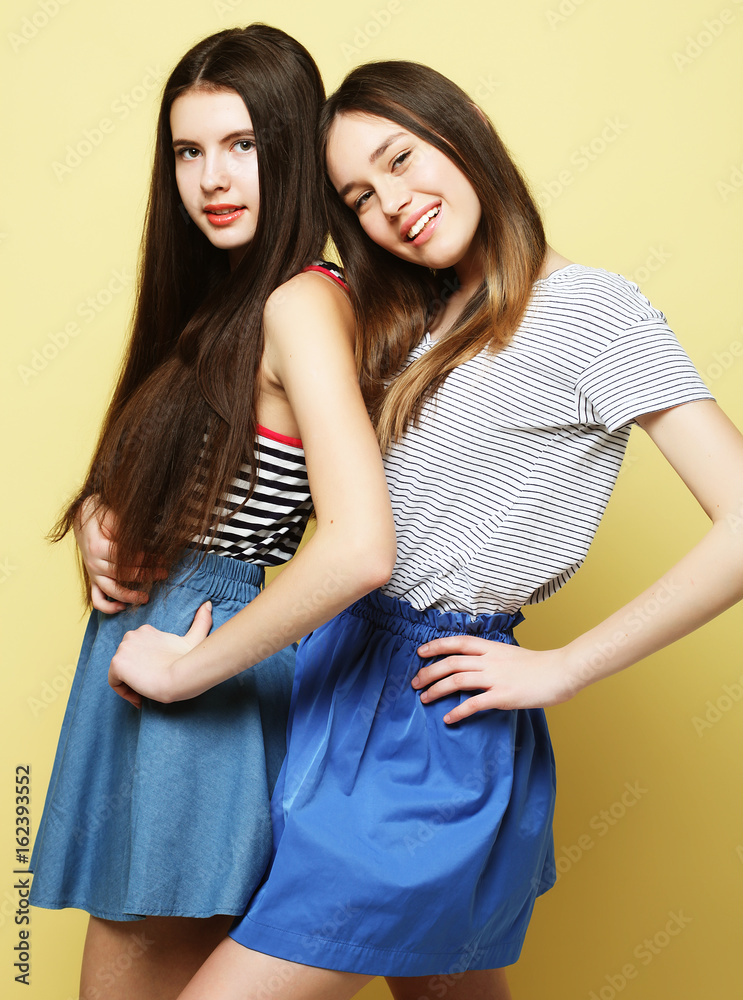 lifestyle and people concept: Two girl friends standing together lifestyle and people concept: Two girl friends standing together