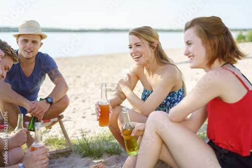 Group of young men and women relaxing on a beach
