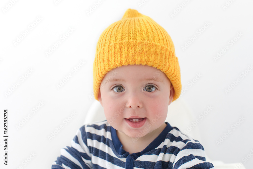 Kid in a yellow hat with two first teeth studio Kid in a yellow hat with two first teeth studio