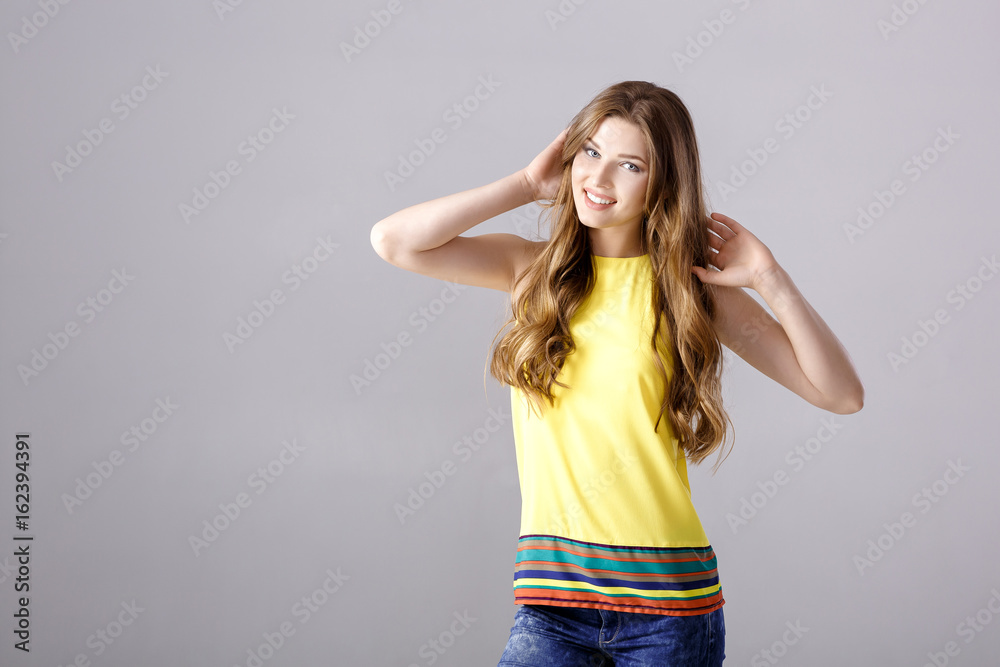 Beautiful young brunette woman with long hair smiling and looking at camera Beautiful young brunette woman with long hair smiling and looking at camera