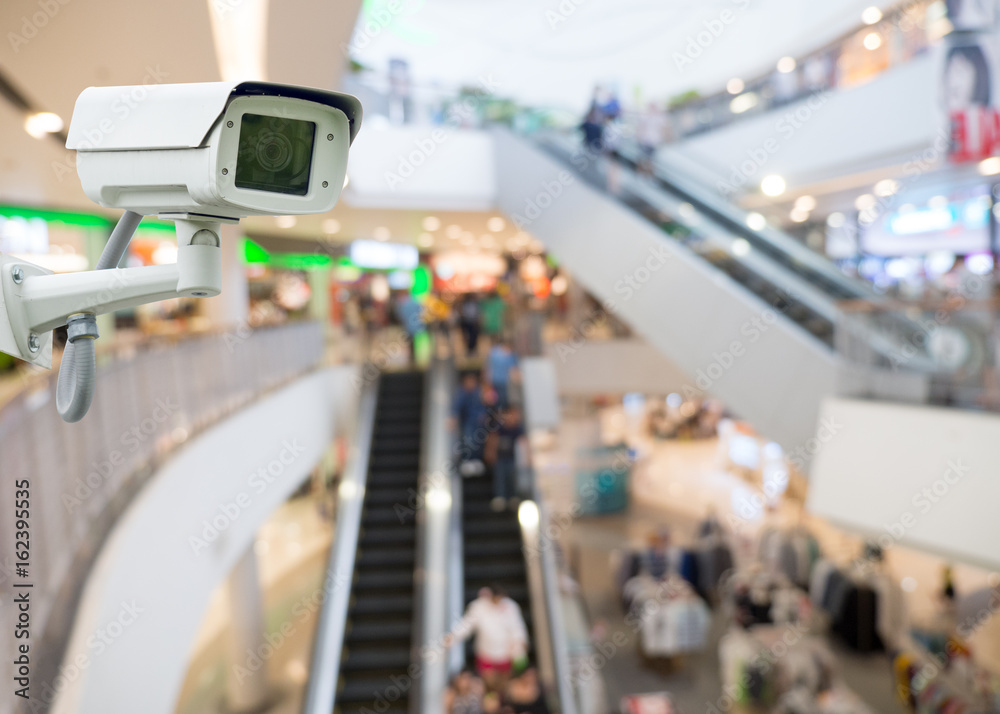 CCTV camera in shopping mall. security camera shopping mall on blurry  background Stock Photo | Adobe Stock