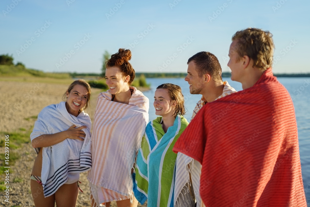 Group of colorful young people wrapped in towels Group of colorful young people wrapped in towels