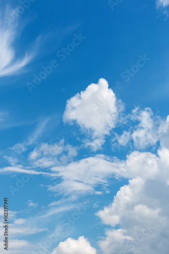 White fluffy big clouds against blue sky