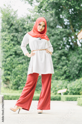 Fashion portrait of young beautiful muslim woman with the red hijab.