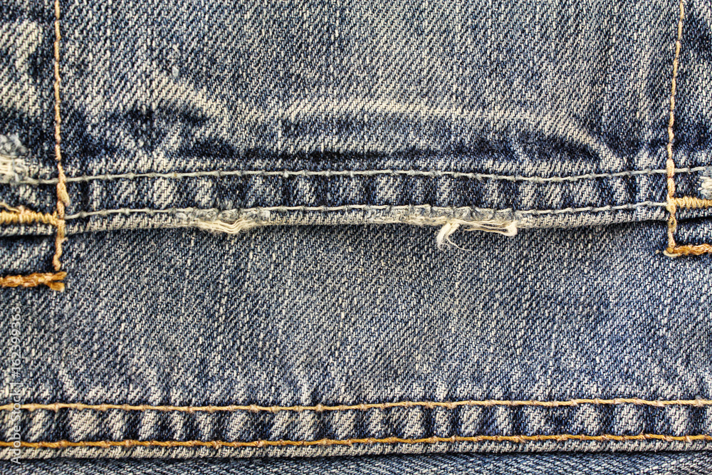 Blue denim jeans texture background with seams,close up,select focus with shallow depth of field Blue denim jeans texture background with seams,close up,select focus with shallow depth of field