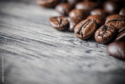 Coffee beans concept on wooden table background.