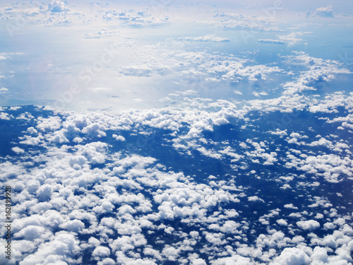 Mid-level cloudscape altocumulus white clouds. Altocumulus middle-altitude cloud in stratocumuliform. View from airplane white flying over sky. photo