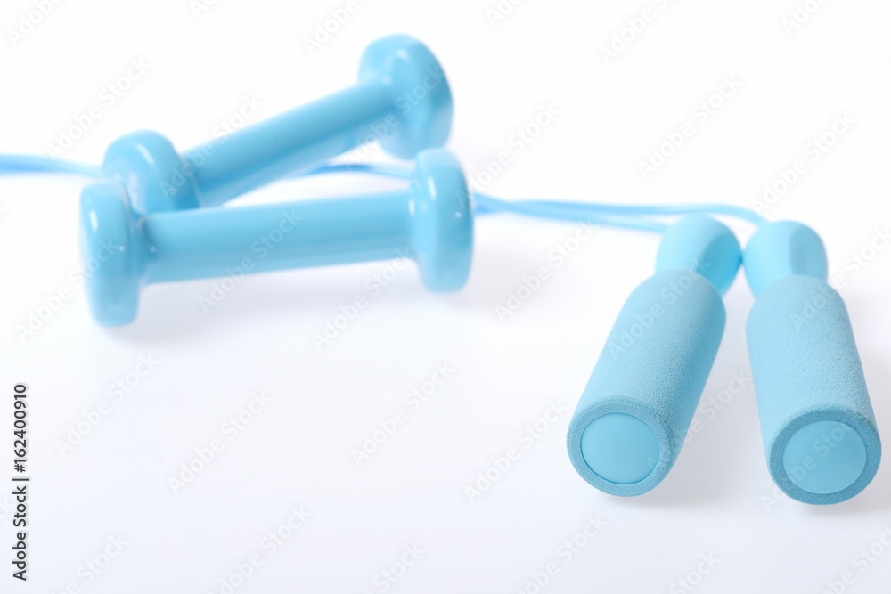 Pairs of skipping rope handles and cyan blue dumbbells Pairs of skipping rope handles and cyan blue dumbbells