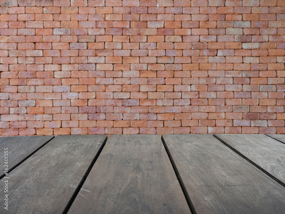 Fototapeta premium Empty top wooden shelves and red brick wall background