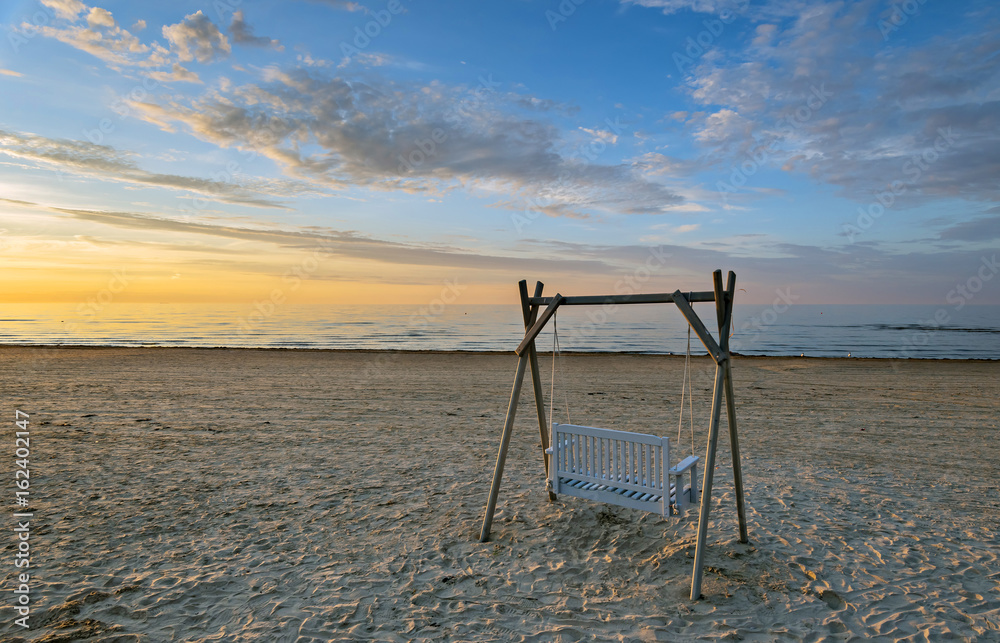Colorful sunrise at a sand beach of Baltic Sea, the shot was taken at a famous international resort Jurmala, Latvia Colorful sunrise at a sand beach of Baltic Sea, the shot was taken at a famous international resort Jurmala, Latvia