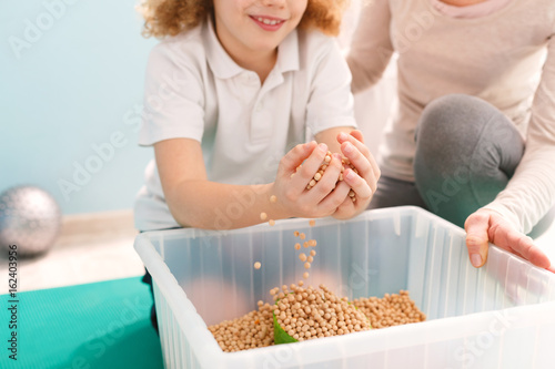 Boy playing with chickpeas