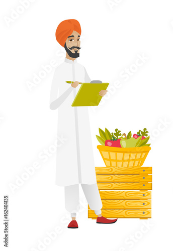Hindu farmer writing on clipboard.