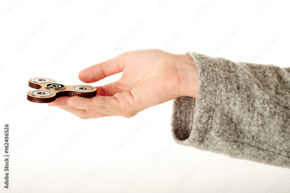 Obraz premium Spinner in hand on white background