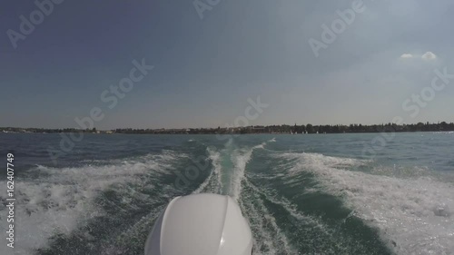 Boat engine view of ocean waves at sunset coast