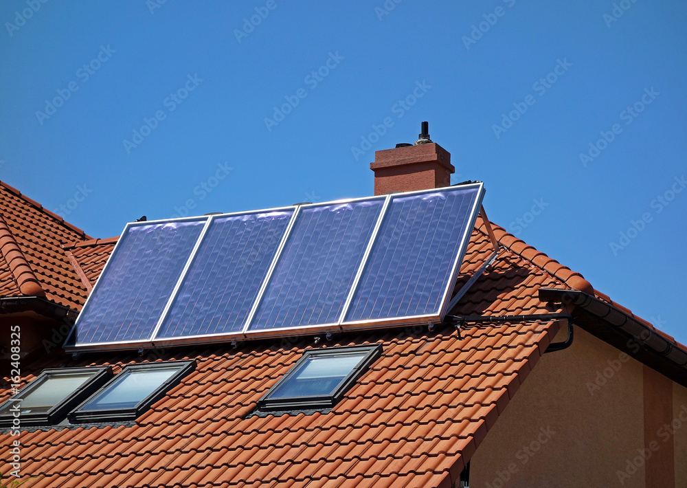 A solar collector on the roof of a family house