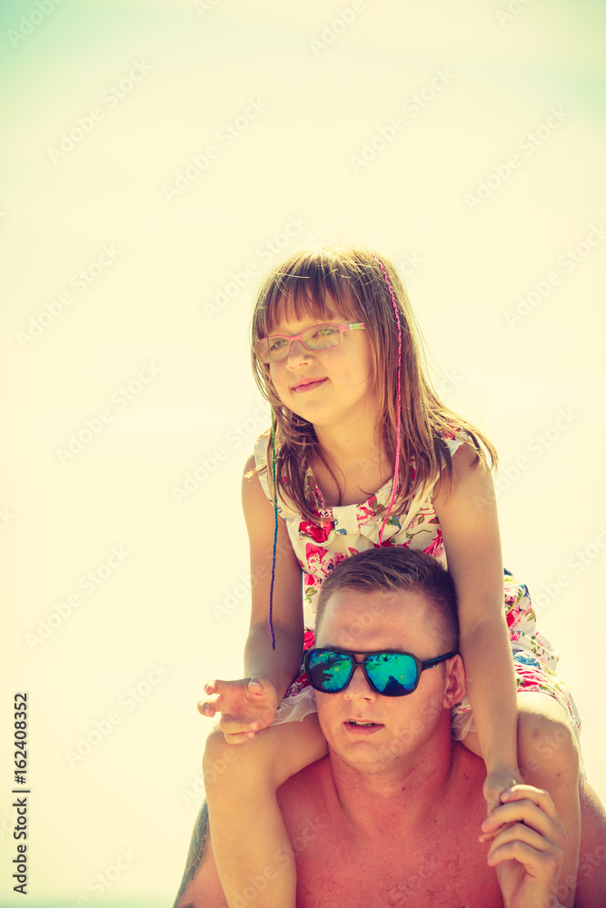 Man with toddler girl on back Man with toddler girl on back