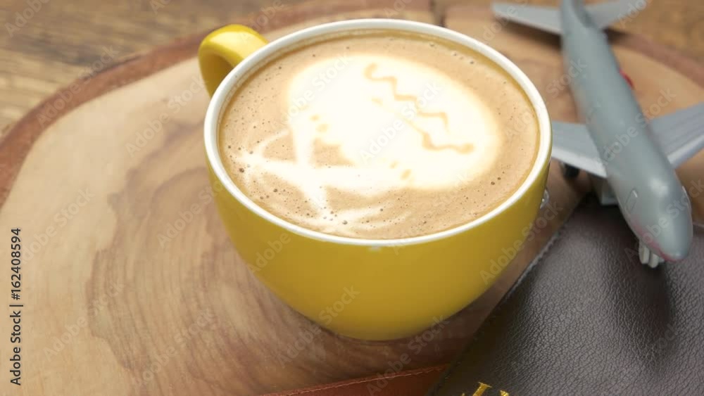 Passports, coffee and toy airplane. Latte cup on wood board. Air travel tips. Passports, coffee and toy airplane. Latte cup on wood board. Air travel tips.