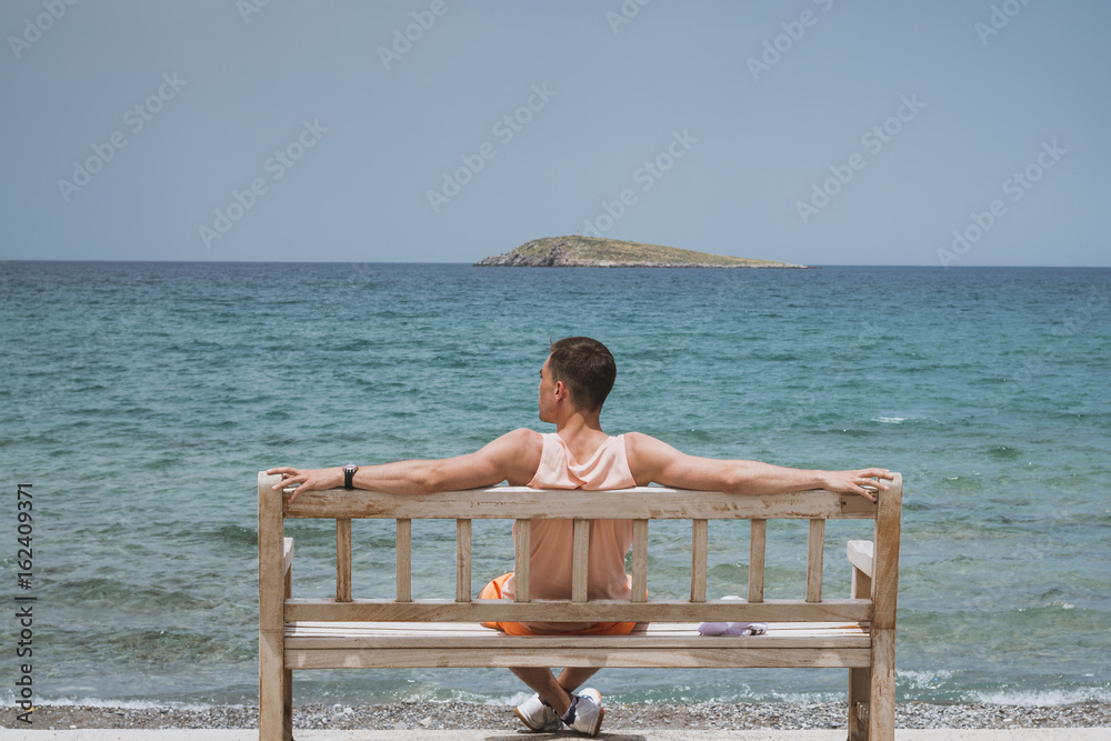 Enjoying life. Young man looking at the sea, vacations lifestyle concept