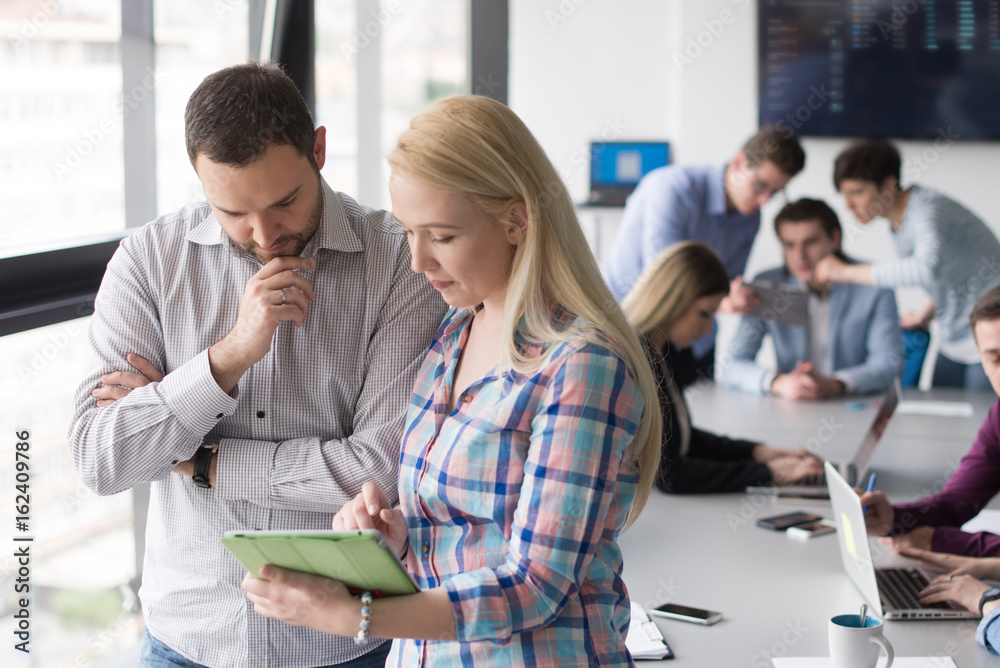 Two Business People Working With Tablet in office