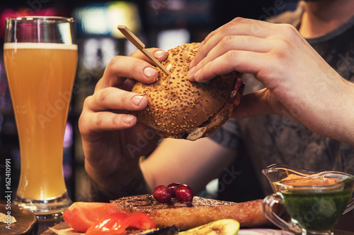 Man eating burgers