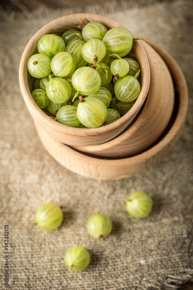 Fresh gooseberry in a wooden bowl. Fresh gooseberry in a wooden bowl.