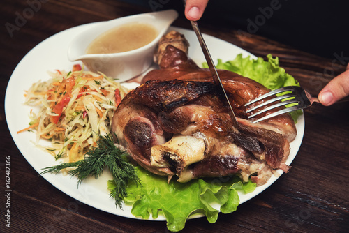 Man eats tasty dish of pork...