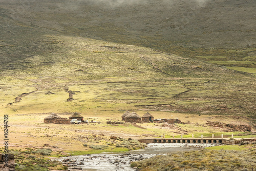 Leshotho landscape with montains, a river and traditional houses, Africa