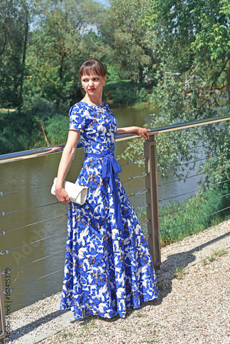 Young woman on river bridge. photo