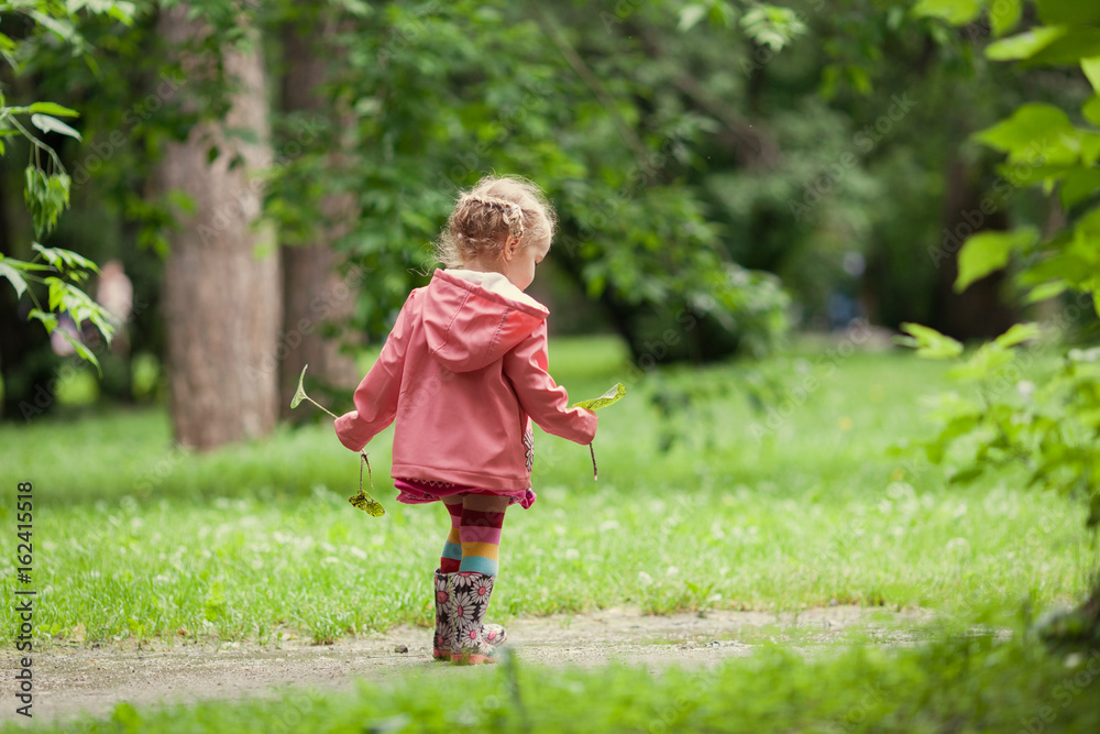 Little beautiful girl walking in a summer park Little beautiful girl walking in a summer park