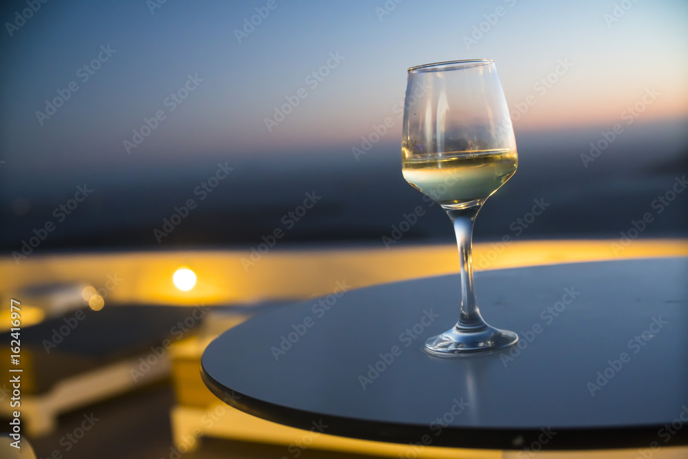 a glass of wine at sunset