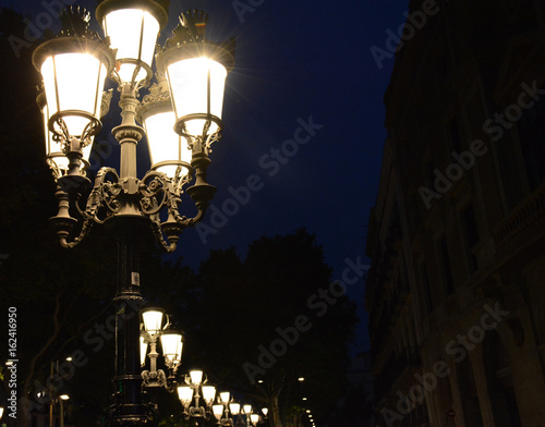 Old street lamp in Barcelona at night photo