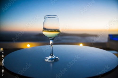 a glass of wine at sunset