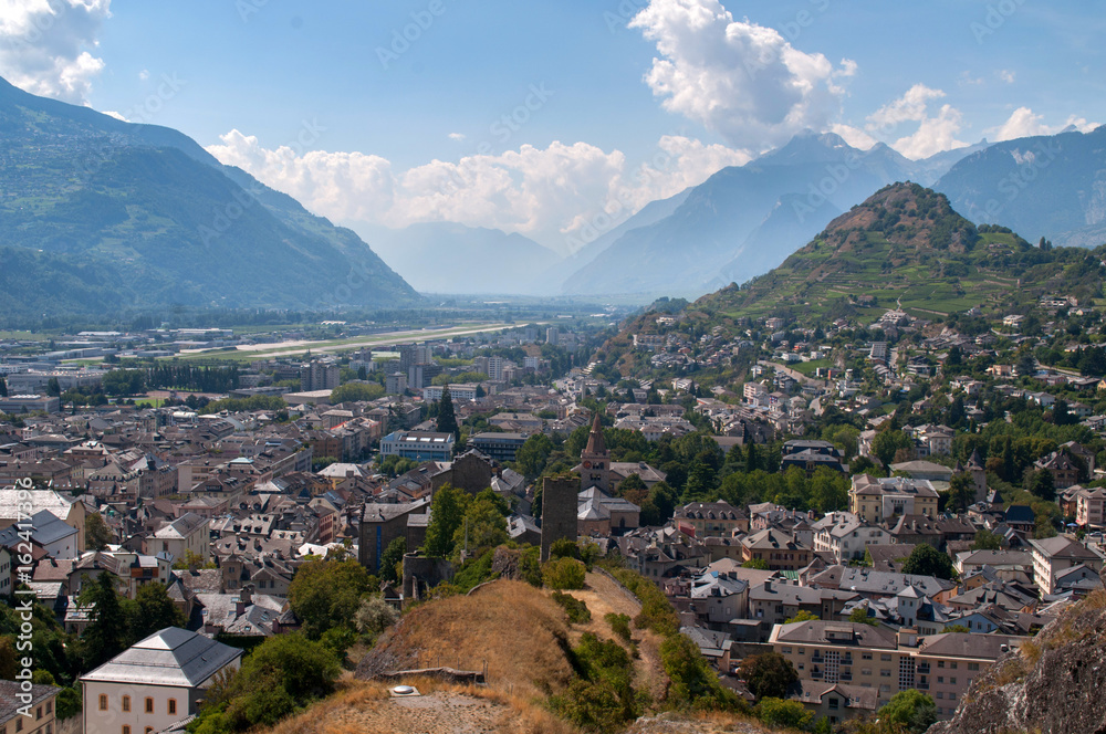 The town of Sion in Switzerland with mountains and countryside nearby.