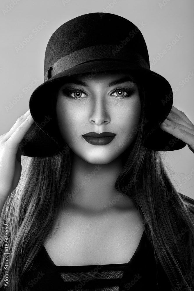 Black and white portrait of beautiful sexy woman in black hat Black and white portrait of beautiful sexy woman in black hat
